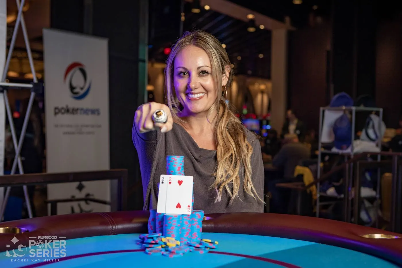 Lexy holding up her RunGood Poker Series championship ring